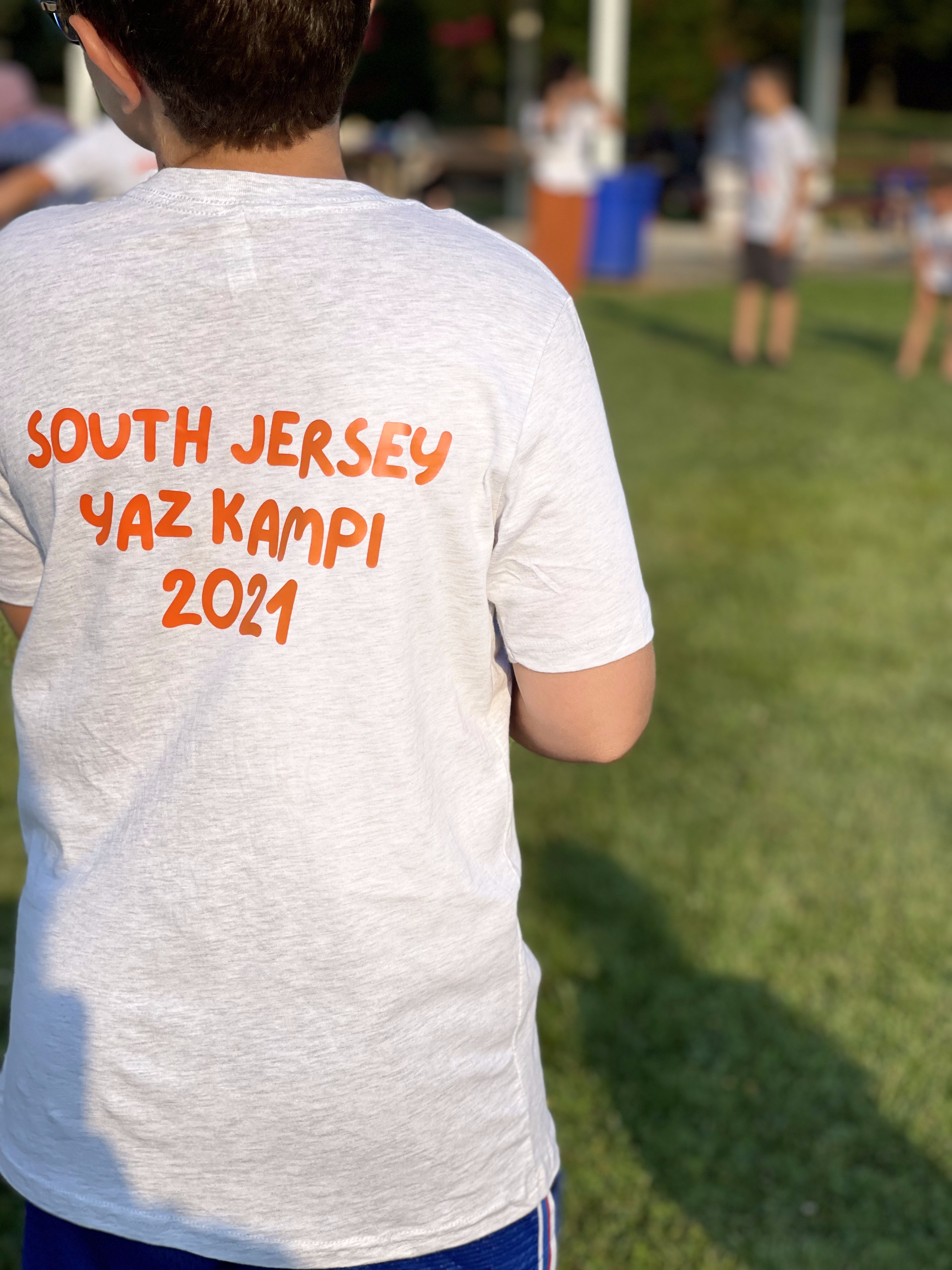 A child wearing a South Jersey Yaz Kampi 2021 summer camp t-shirt