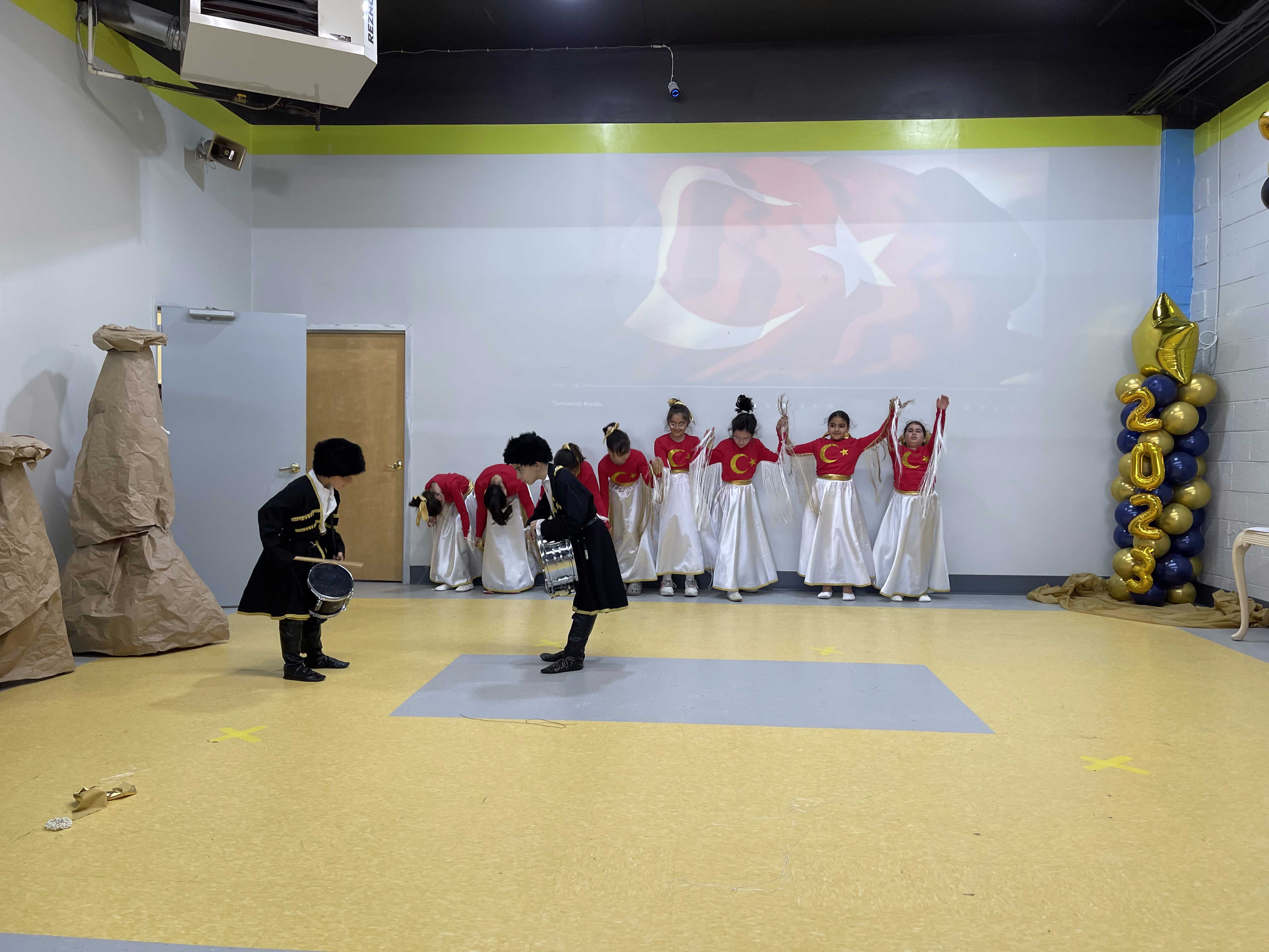 Children in traditional costume performing at the closing ceremony of the 2023 Weekend School Program
