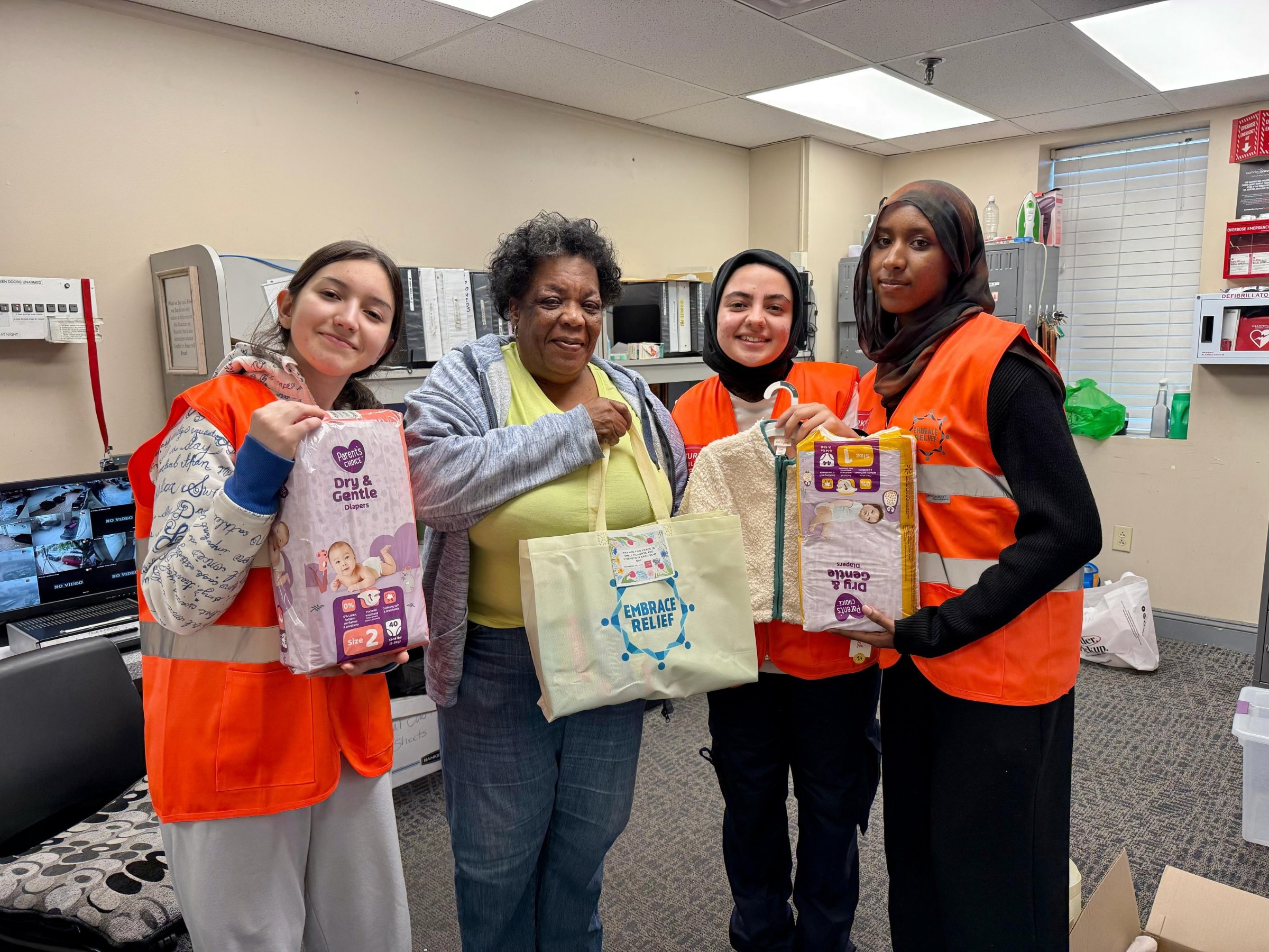 Insight Foundation volunteers in safety vests preparing donation bags for a community service project